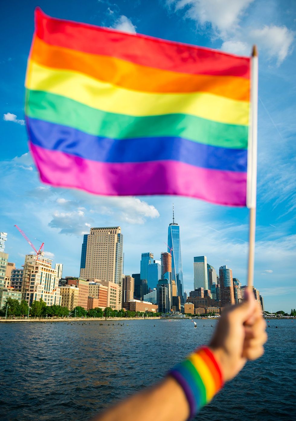rainbow flag NYC skyline downtown freedom tower