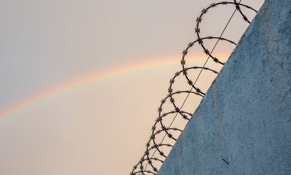 Rainbow over prison barbs