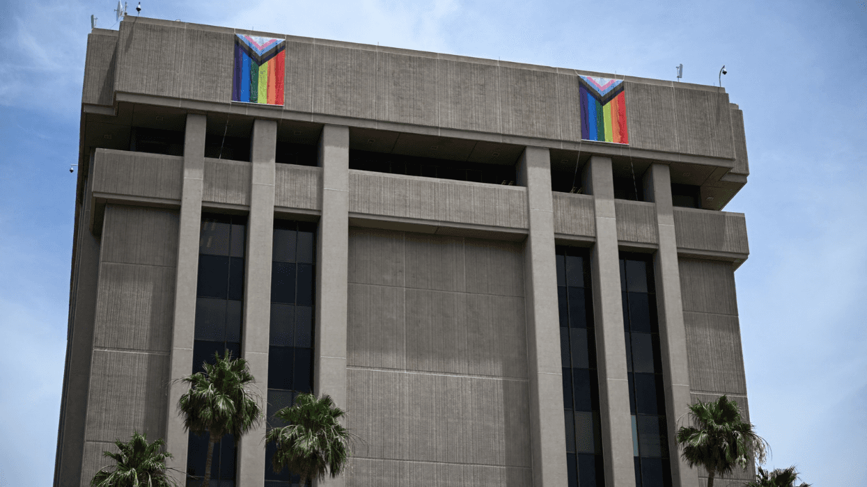 Rainbow Pride flags hang from the Arizona State Capitol Executive office building.