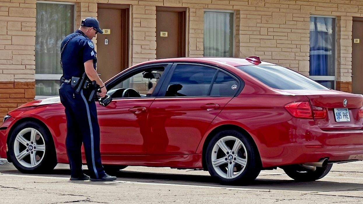 red bmw with a police officer talking to driver