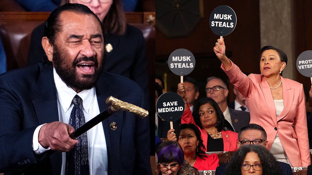 Rep Al Green Texas raises his cane Nydia Velázquez stands among politicians holding paddles saying Musk Steals