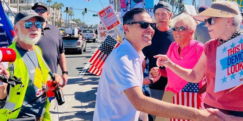 rep robert garcia shaking supporters' hands
