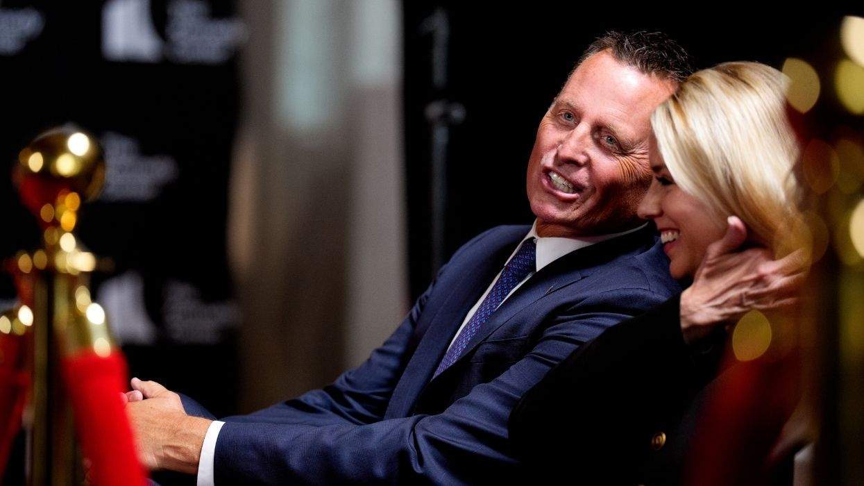 ric grenell talking to pam bondi at a kennedy center event with a velvet rope in the foreground