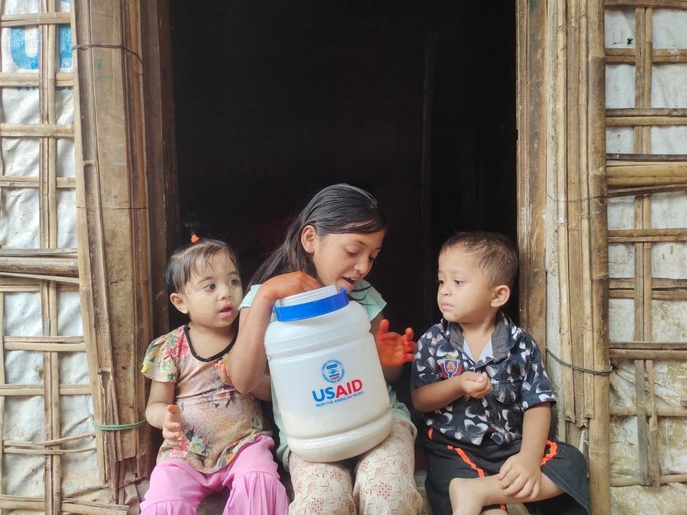 Rohingya children eat meals provided by USAID funding\u200b