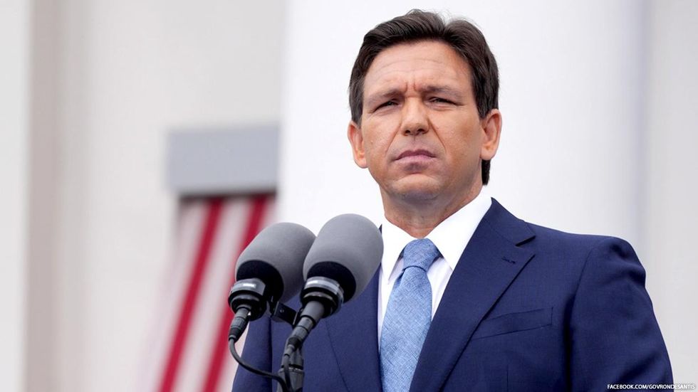 Ron DeSantis standing in front of building about to make a speech