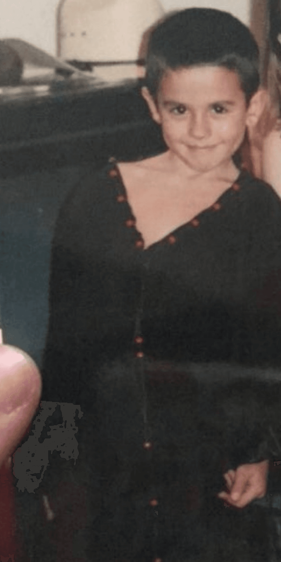 Rose Montoya poses in a dress as a child.