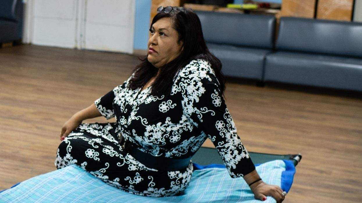 Ruby Corado sitting on a cot