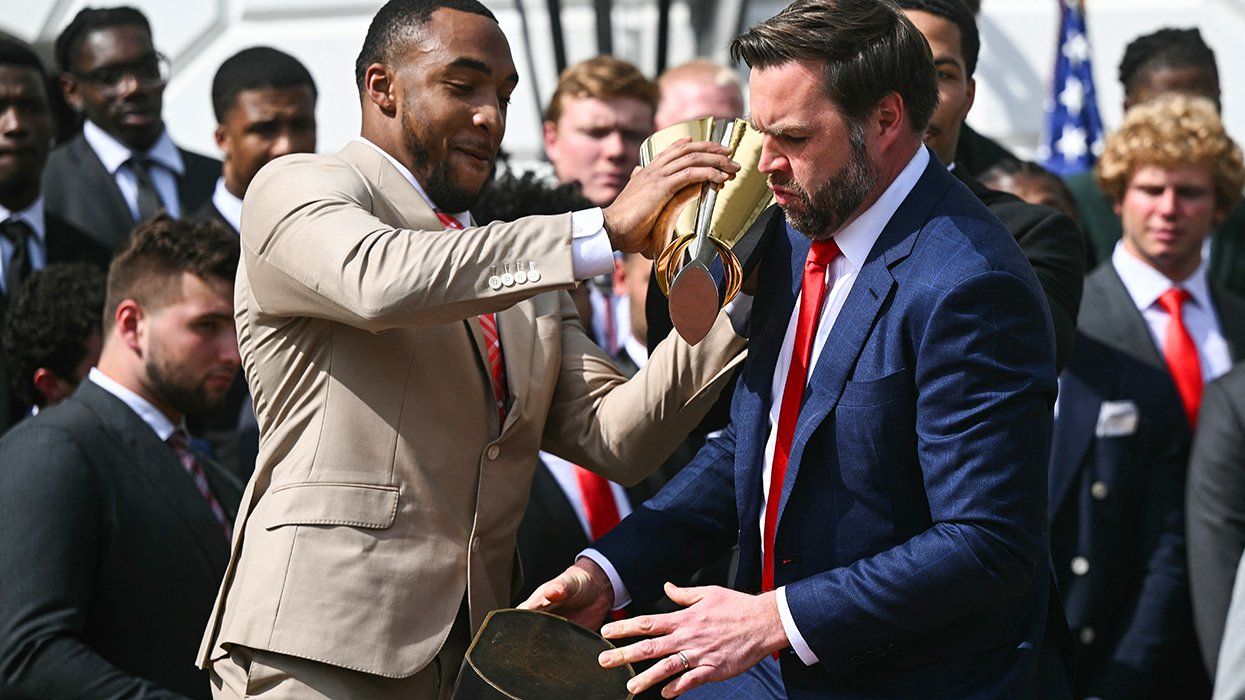 Running back TreVeyon Henderson holding and US Vice President JD Vance dropping the College Football Playoff National Championship Trophy white house washington DC