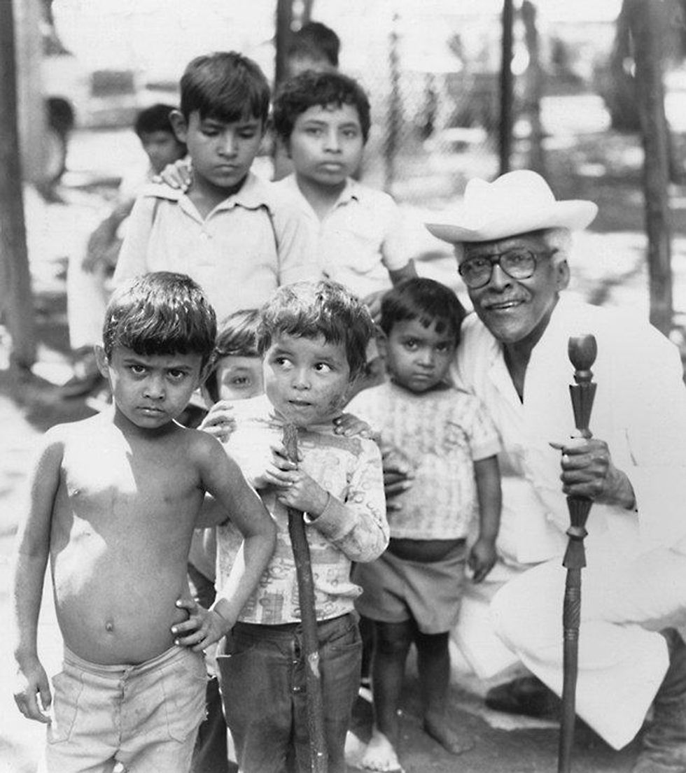 Rustin with children displaced by civil unrest in El Salvador, 1983. Courtesy Bayard Rustin Estate.
