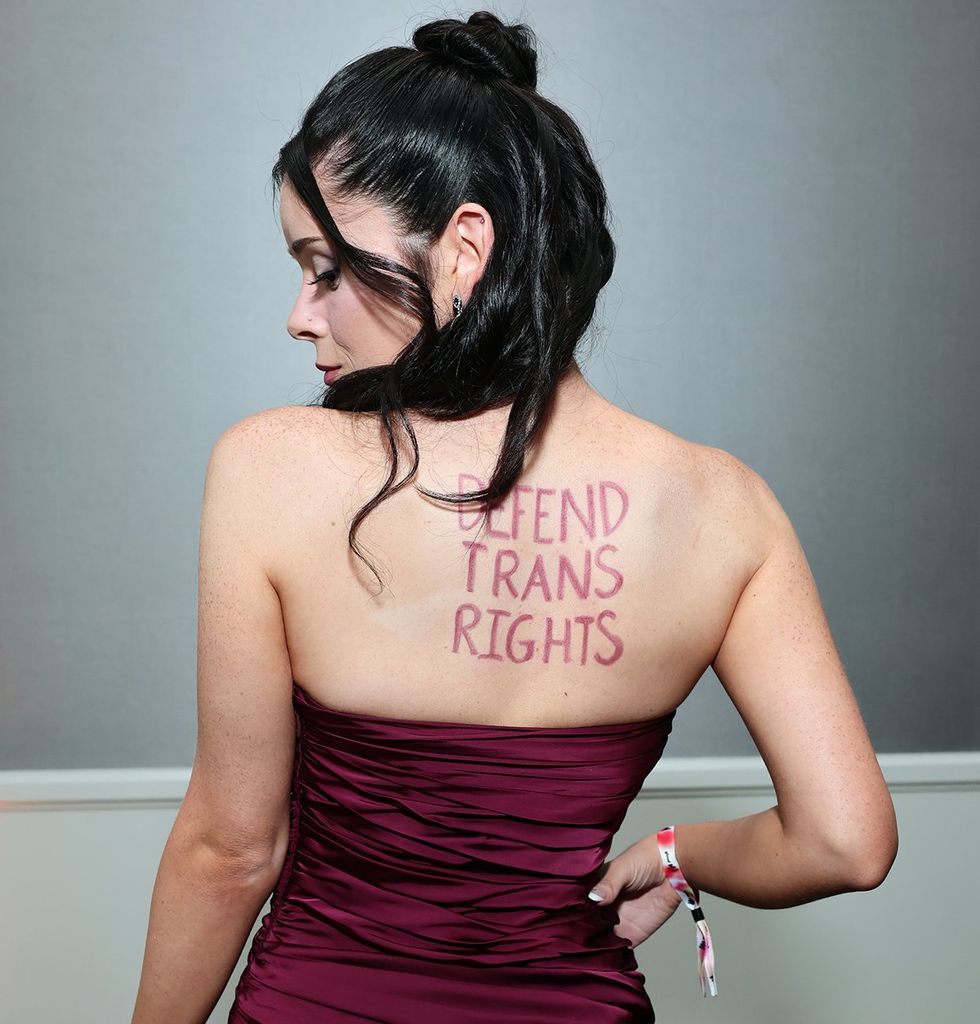 Samantha Lux attends the 36th Annual GLAAD Media Awards 2025 Defend Trans Rights written in makeup across her back