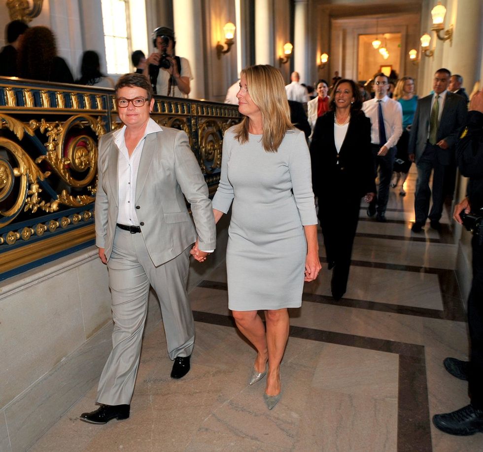 samesex lesbian couple Kris Perry Sandy Stier walking halls San Francisco City Hall after their wedding followed by officiant California Attorney General Kamala Harris 2013