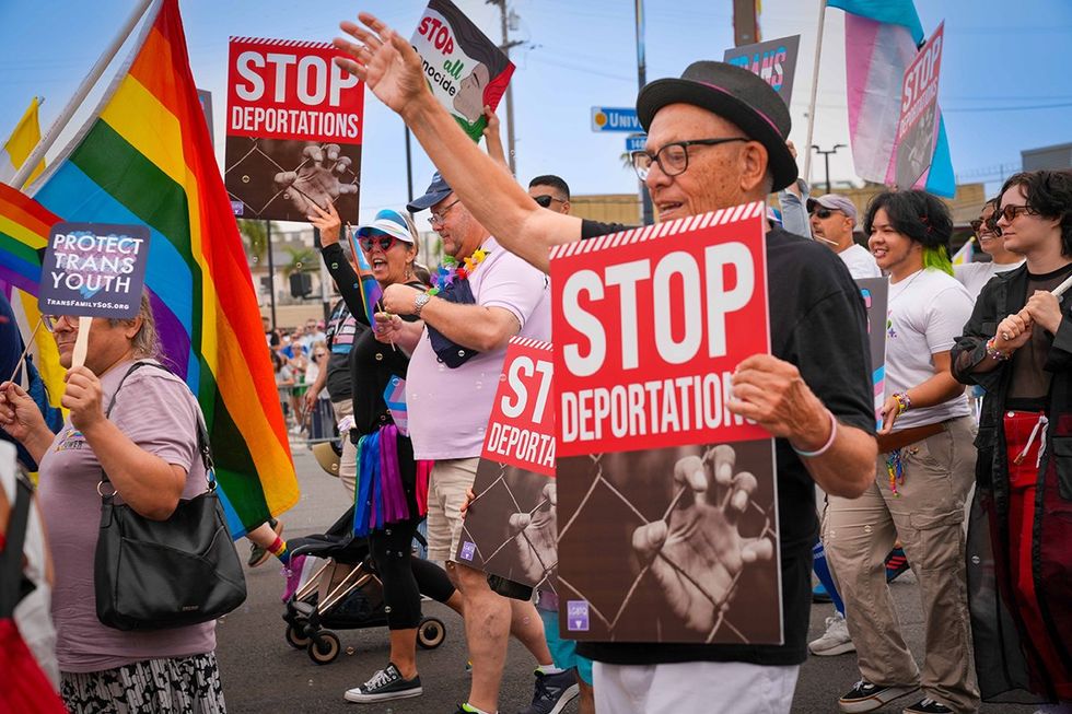 San Diego LGBTQIA Pride parade 2025 signs say Stop deportations Protect trans youth
