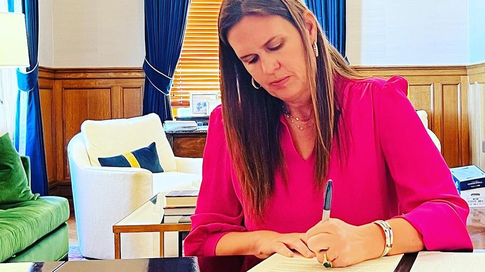 Sarah Huckabee Sanders Signing Documents