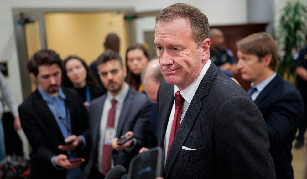 sen. eric schmitt surrounded by reporters