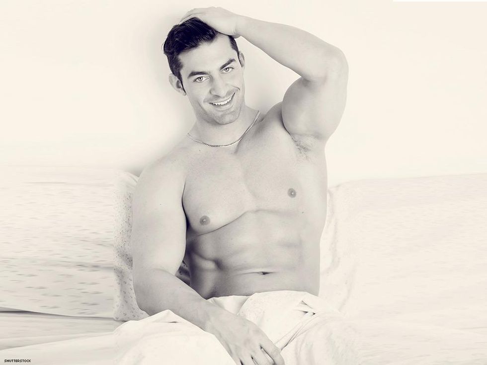 sexy man in bed smiling relaxed