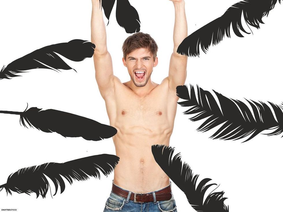 shirtless man in jeans with arms up with lots of feather shadows around him
