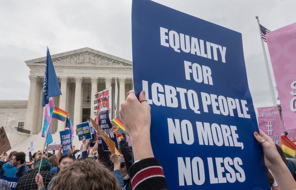 Sign outside SCOTUS reading "Equality for LGBTQ people no more, no less"