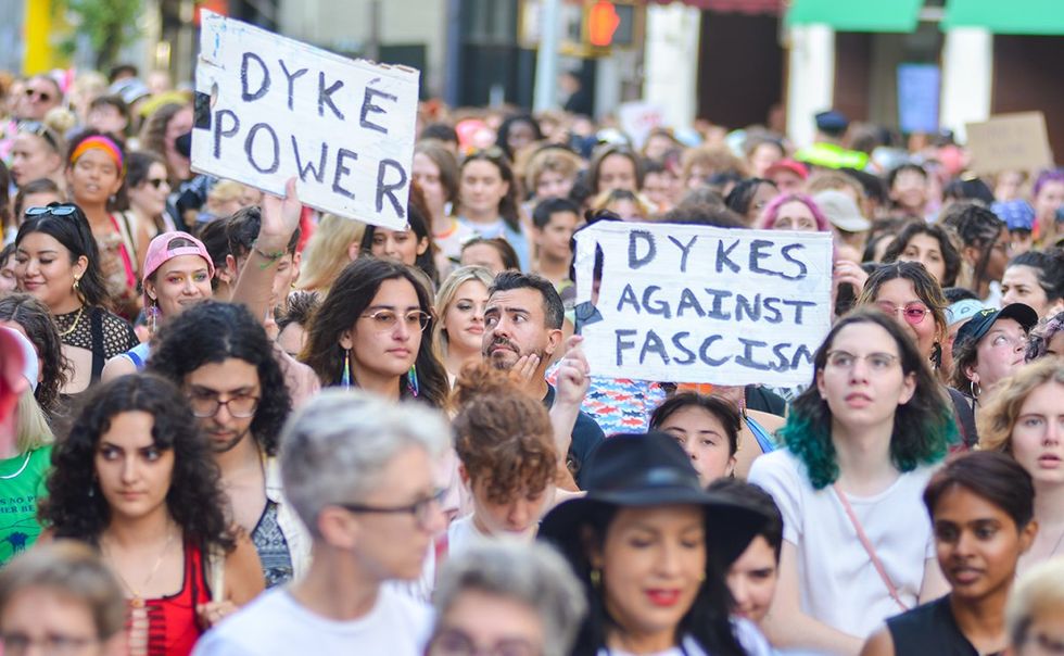 signs saying dyke power dykes against fascism Thousands march New York City during the 31st Annual Dyke March along Fifth Avenue