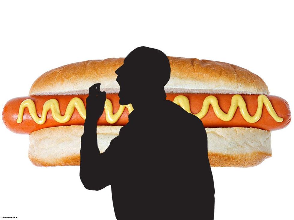 silhouette of man with breath spray over hot dog