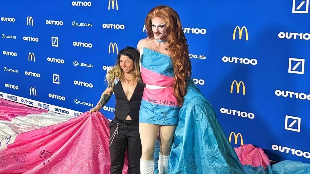 SJ and Pattie Gonia walk the 2025 Out100 carpet with massive trans pride flag that hung in Yosemite National Park
