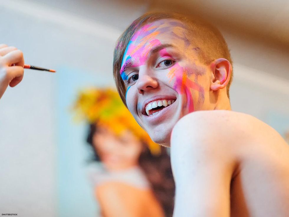 smiling person with body paint on their face