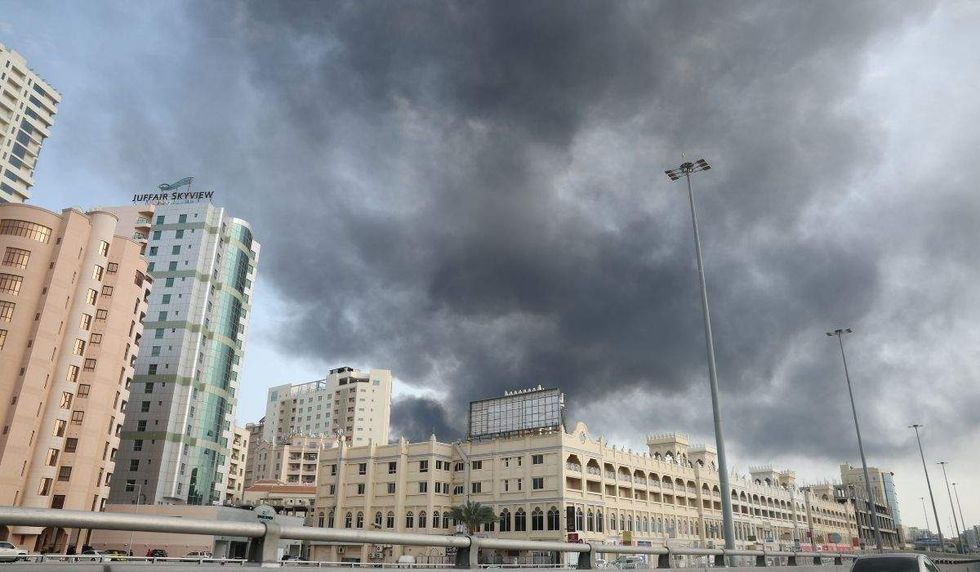 smoke billows over buildings in bahrain