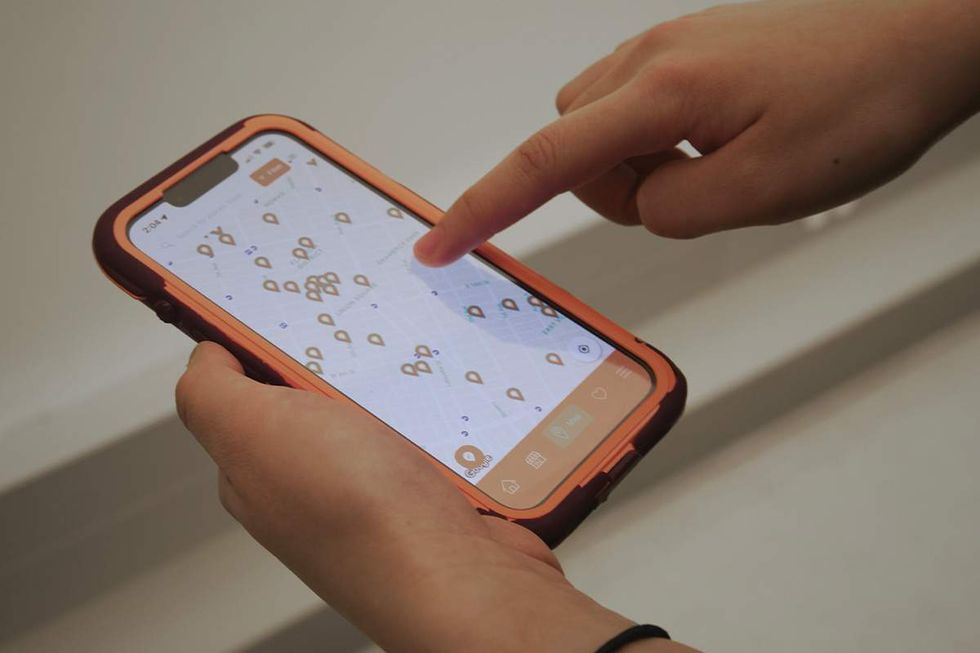 someone using the Everywhere is Queer app on a mobile phone