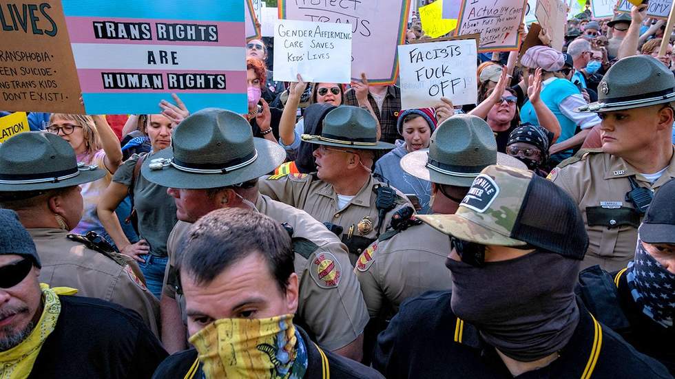 State Police stand between members of the Proud Boys and LGBTQ transgender counter protestors during a protest against gender affirming care by Vanderbilt University Medical Center at the War Memorial Plaza in Nashville Tennessee
