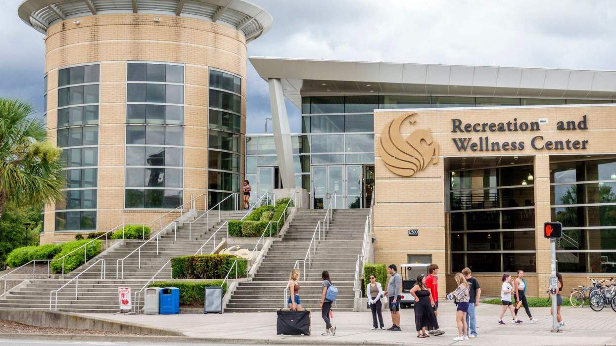 students gather outside of the UCF recreation and wellness center building