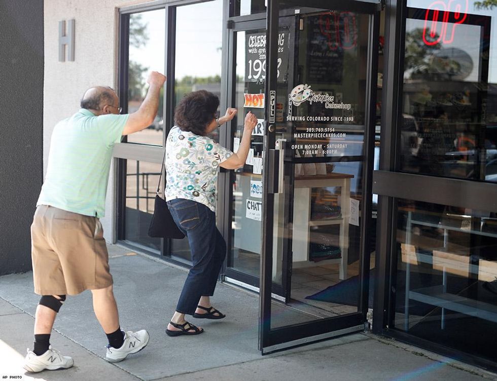 Supporters raise their arms as they head in to visit baker Jack Phillips at Masterpiece Cakeshop.