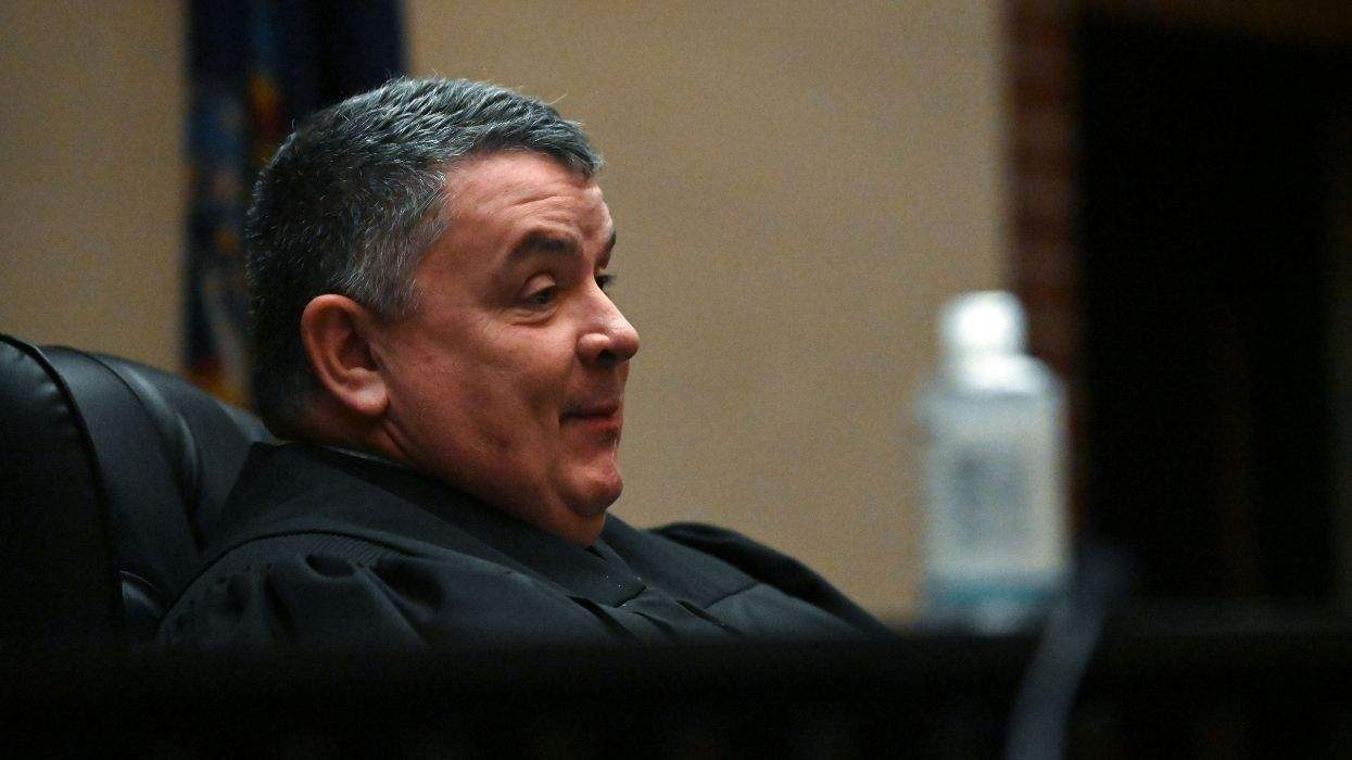 supreme court justice james e walsh sitting in his robe