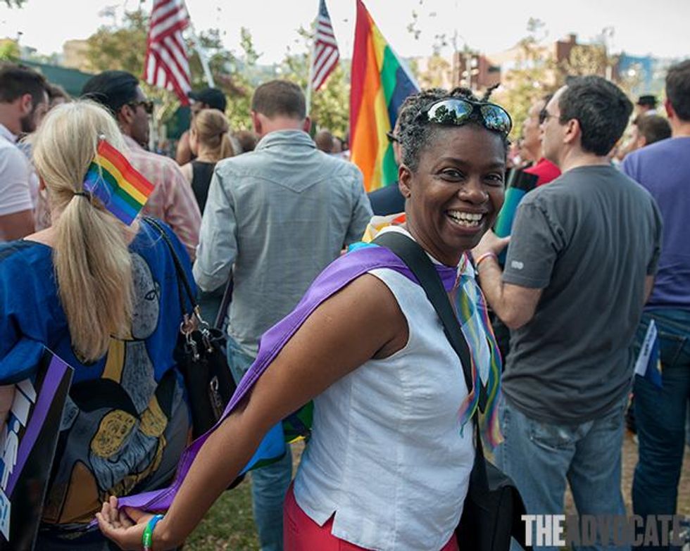 Surrounded by rainbow flags.