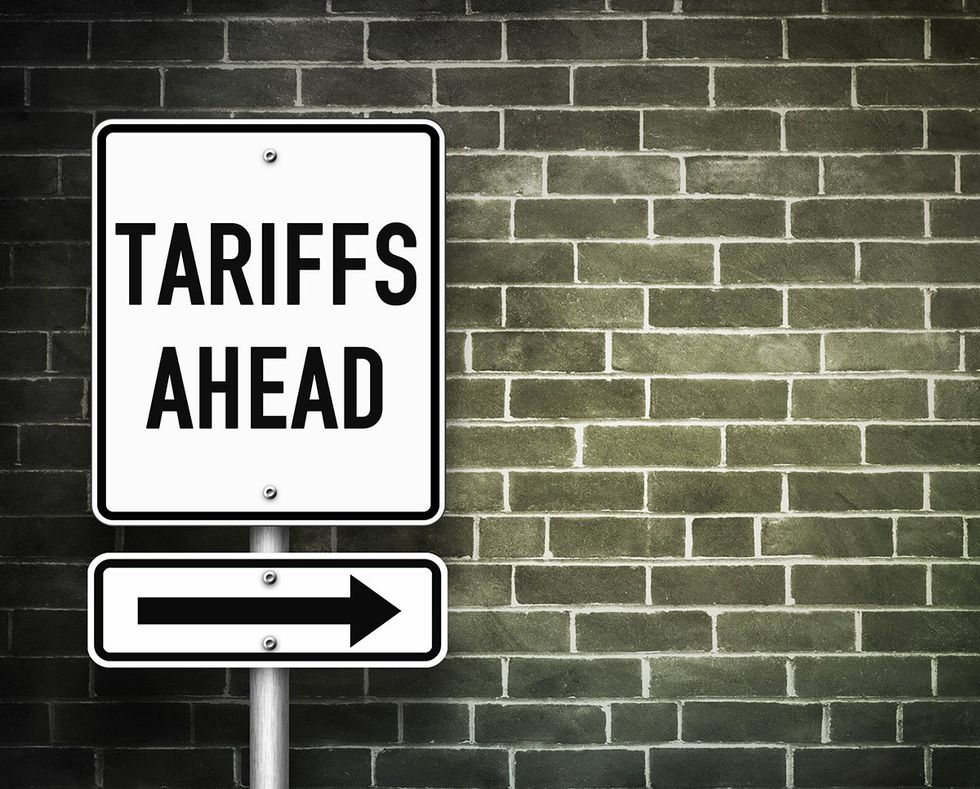 Tariffs ahead traffic sign against brick wall illustration