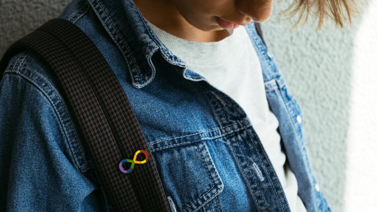 Teen boy with rainbow infinity autism pin