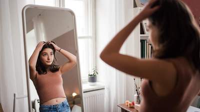 teenage girl looking in a mirror