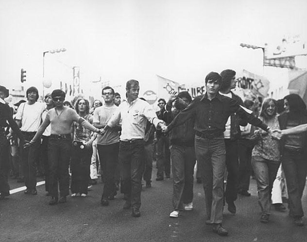 The crowd holds hands at the Los Angeles Christopher Street West pride parade, 1971