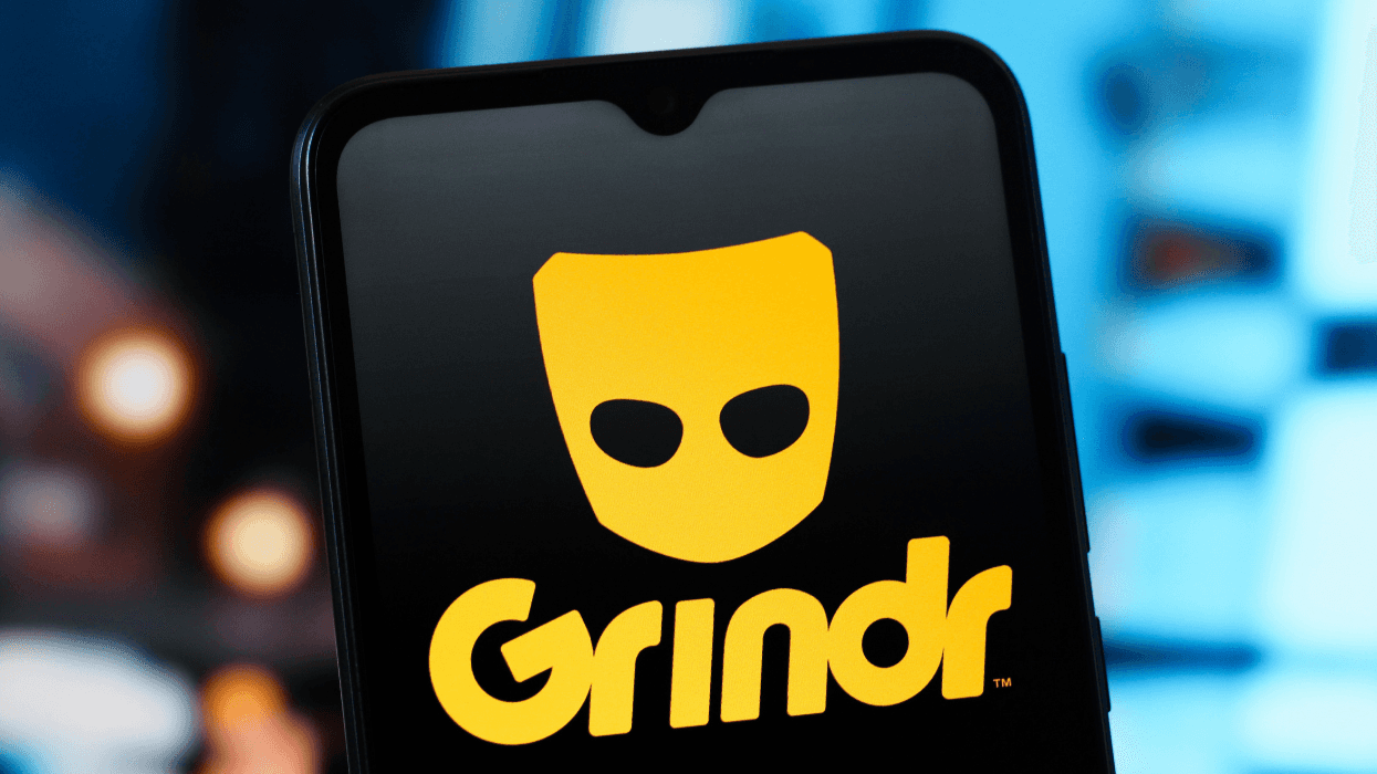 The Grindr logo is displayed on a smartphone.