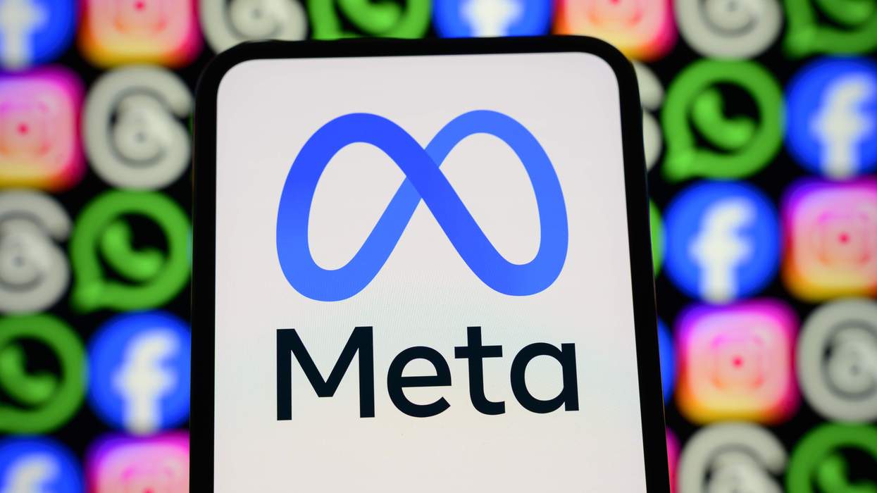 The Meta logo appears on a smartphone screen in front of a screen showing icons for Facebook, Instagram, WhatsApp, and other Meta apps.