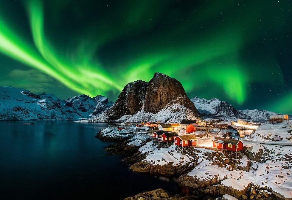 The Northern Lights over the picturesque fishing village of Hamn\u00f8y, Norway