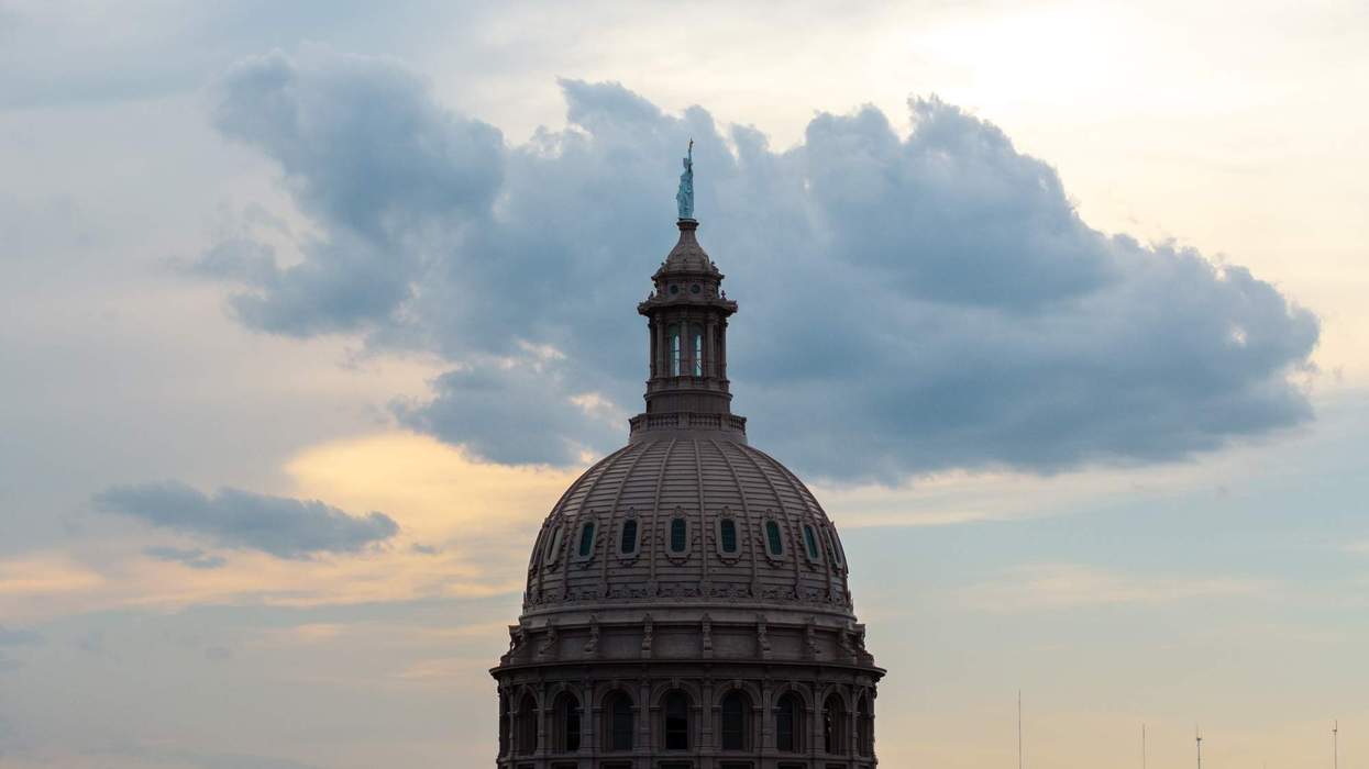 The Texas State Capitol sits before a sunrise.