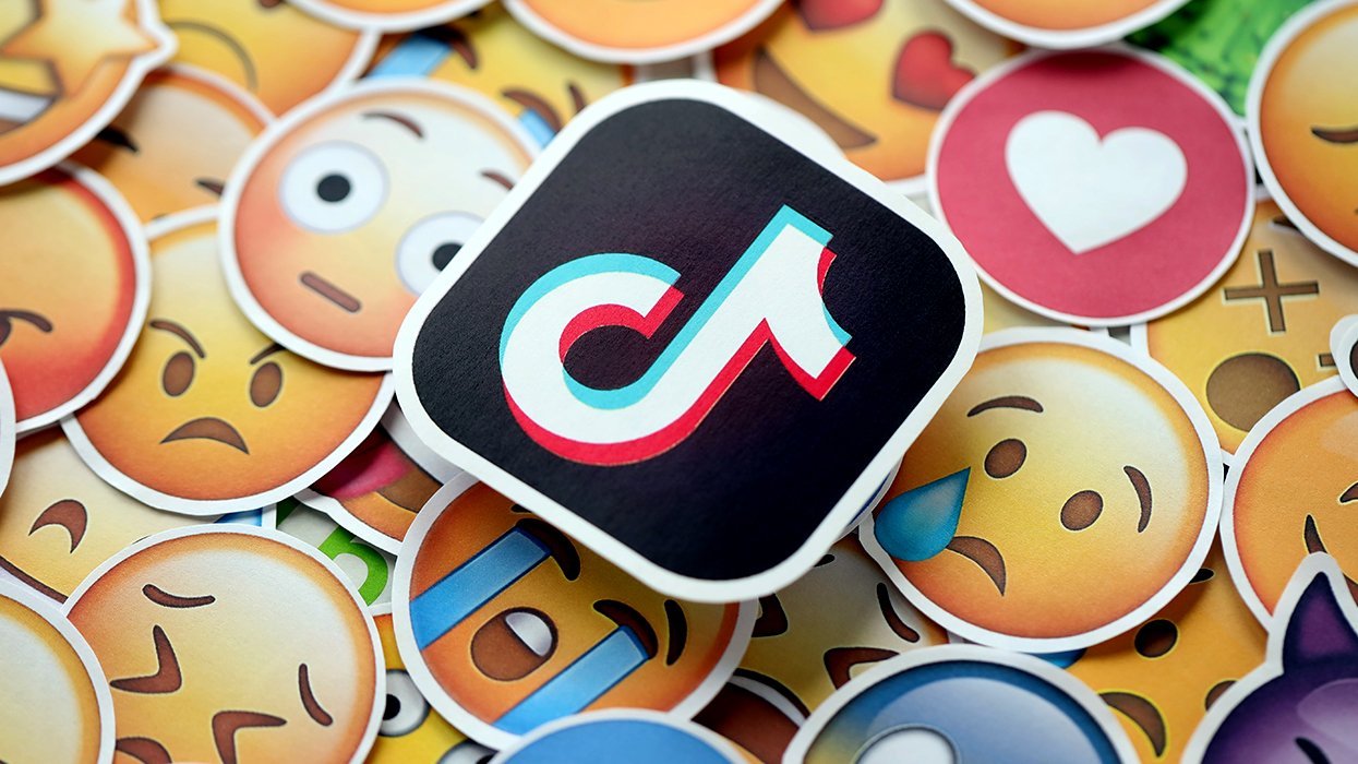 tiktok logo sticker on top of many emoji stickers