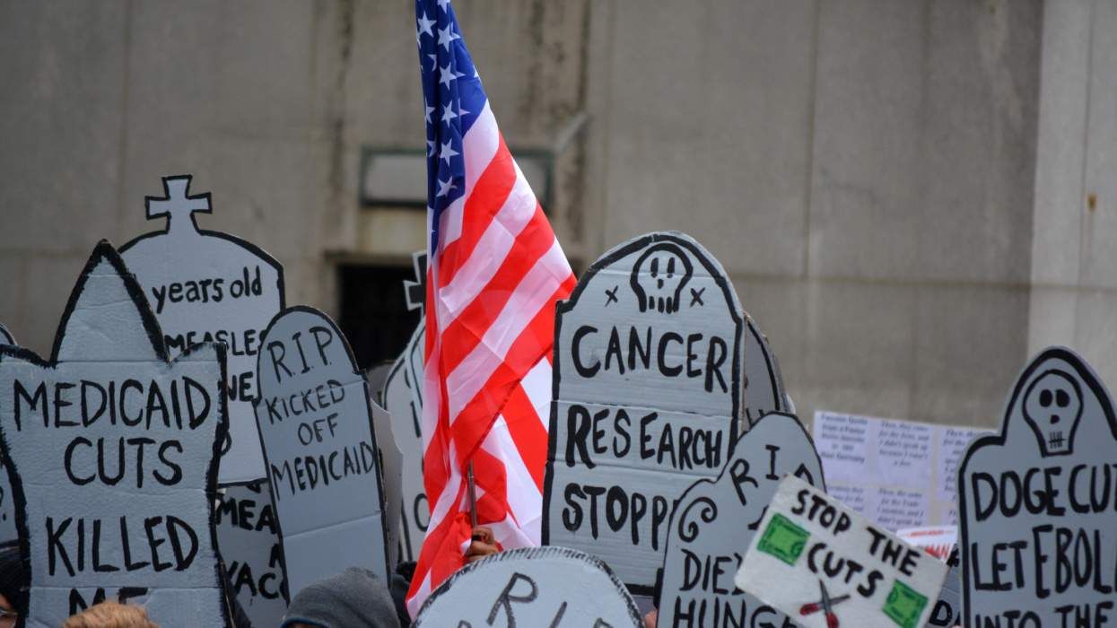 Tombstone protest signs against DOGE cuts