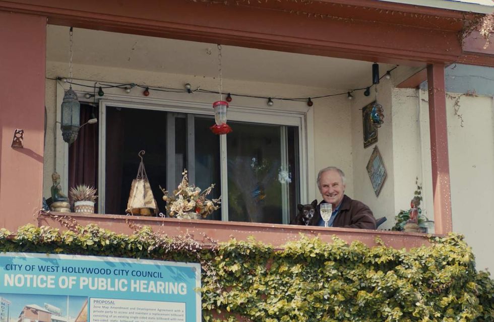 Tony Powell sits on the balcony of the Holloway Motel with his beloved chihuahua Samantha