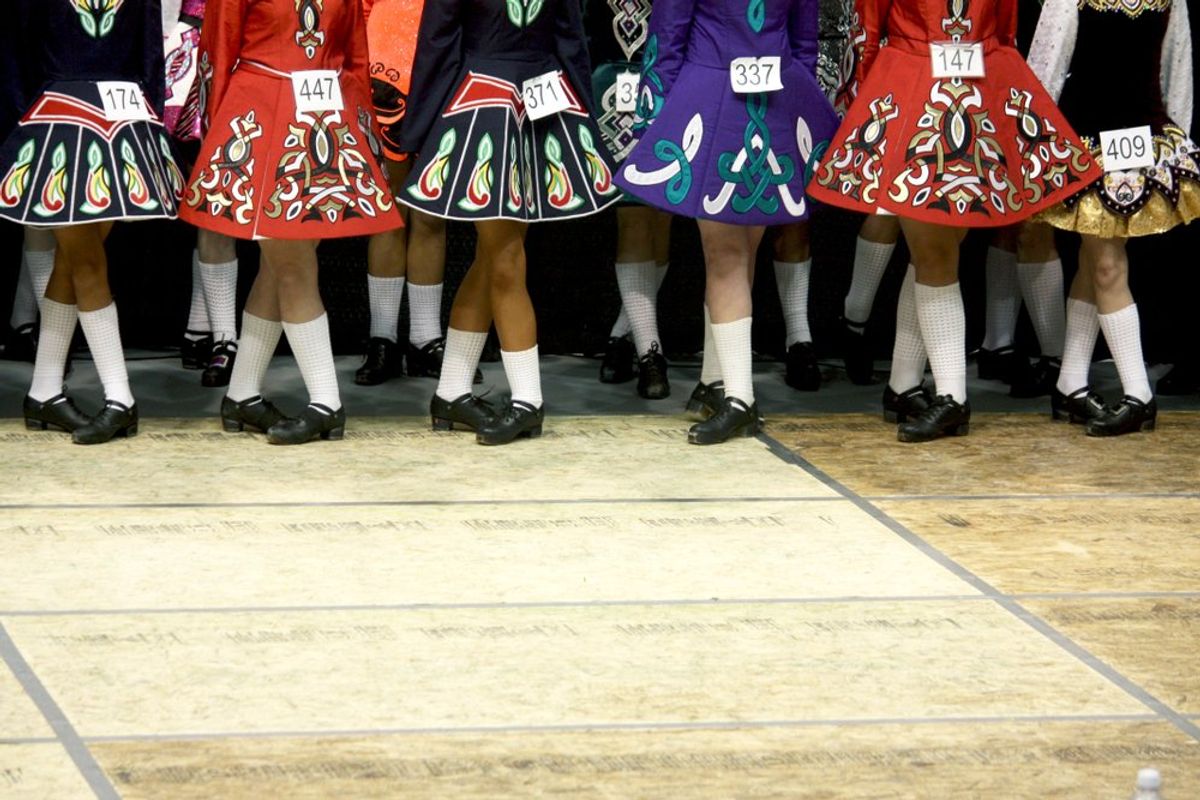 Traditional Irish dancers with competition numbers
