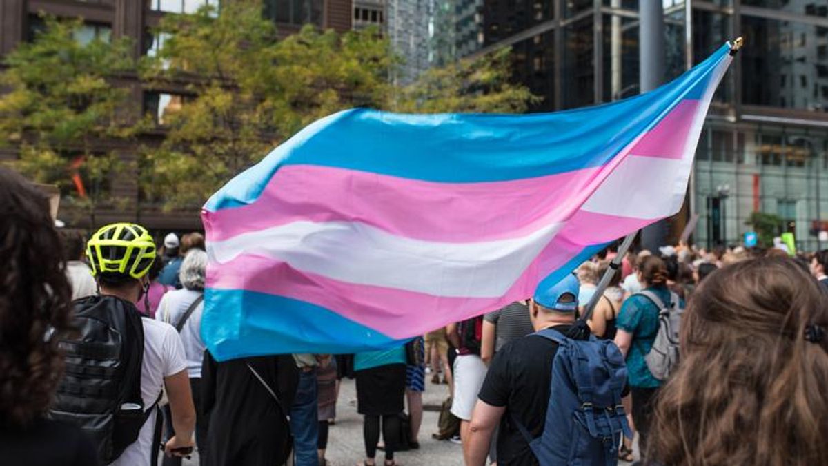 Trans flag holder in crowd