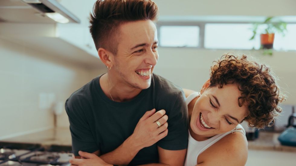 Trans man and his female partner laughing