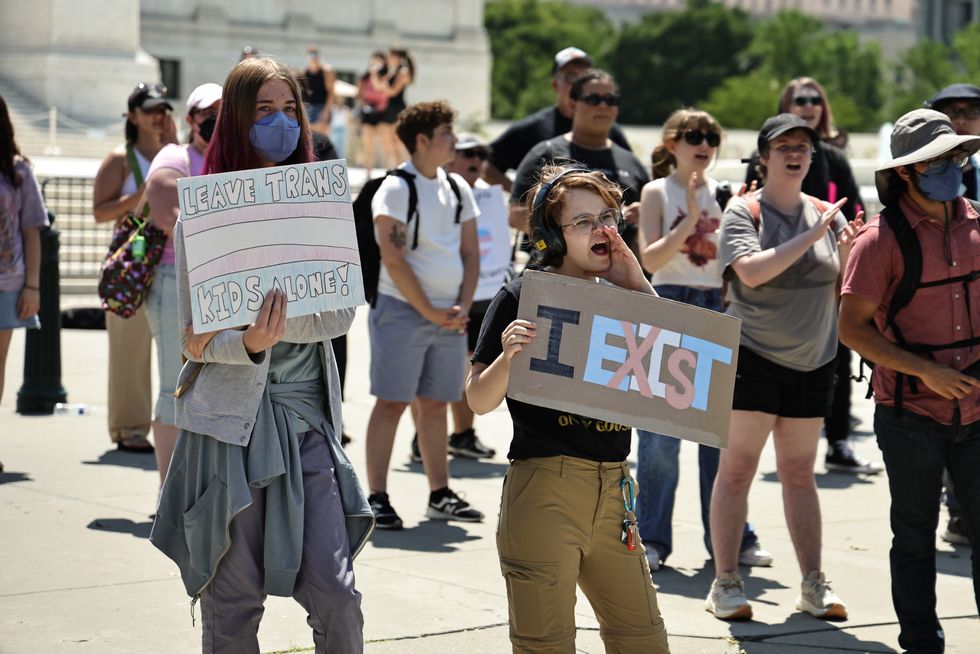 Trans youth hold protest signs outside SCOTUS\u200b