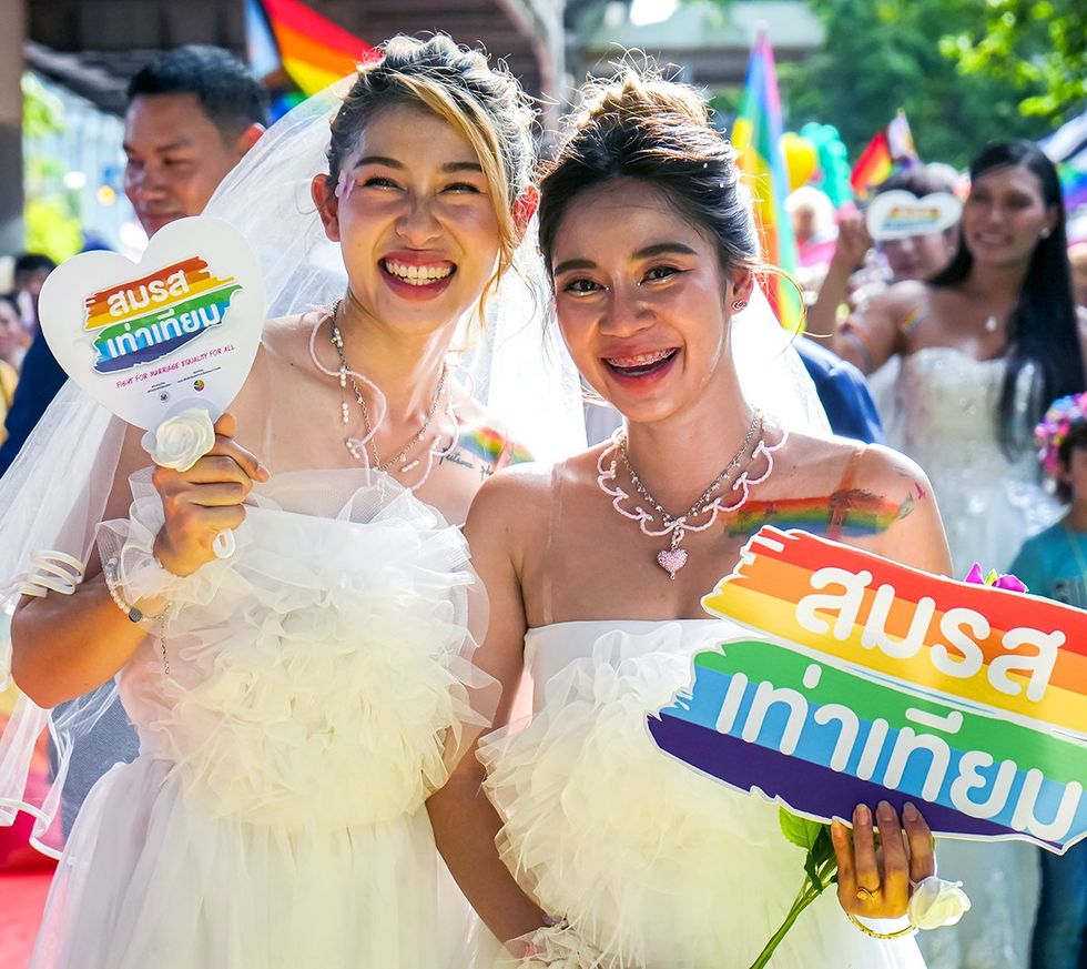 two brides march through central Bangkok 2023 Thailand LGBTQIA Pride month