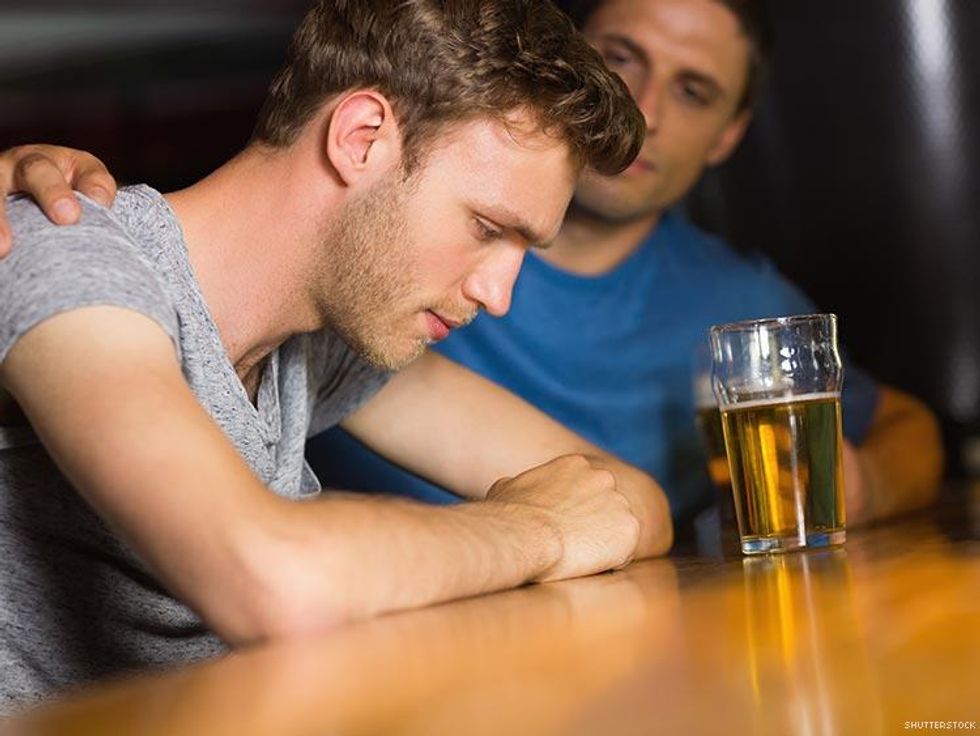 two men having serious conversation over beer