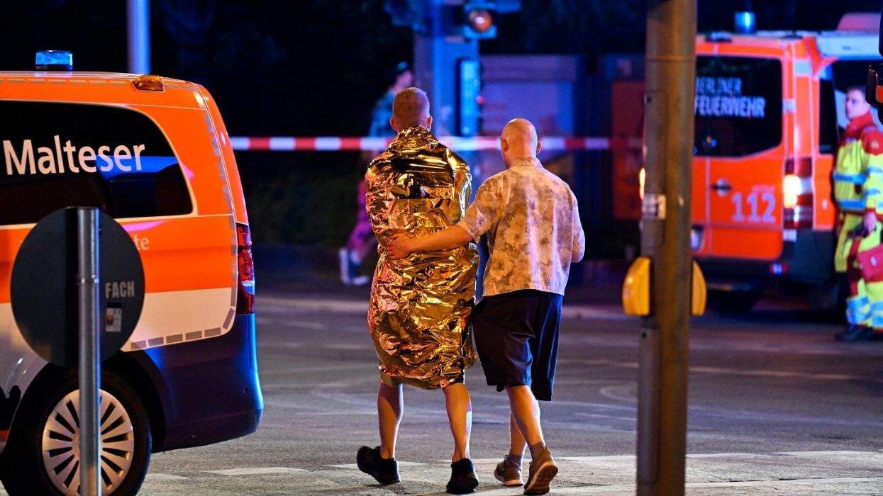 two men walking between emergency vehicles
